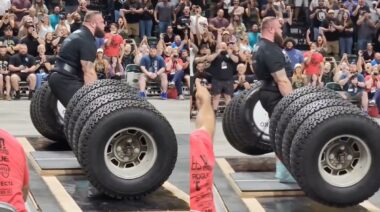 Oleksii Novikov deadlifting hummer tires loaded onto a barbell at the 2022 Shaw Classic