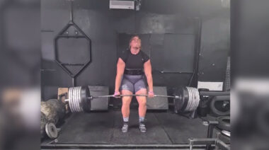 A woman deadlifting in a gym.