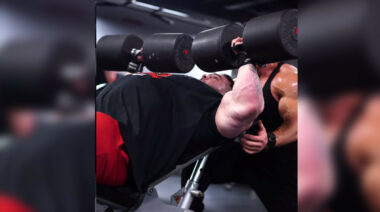 Bodybuilder performing incline dumbbell presses.