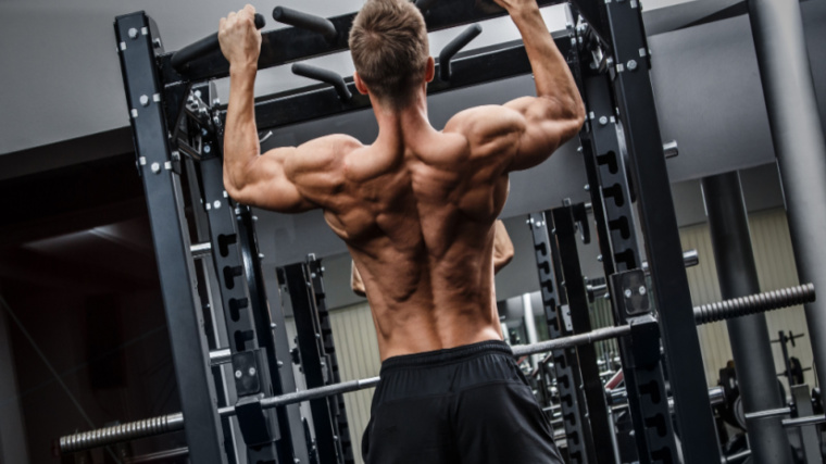 man performs pull-up with wide grip