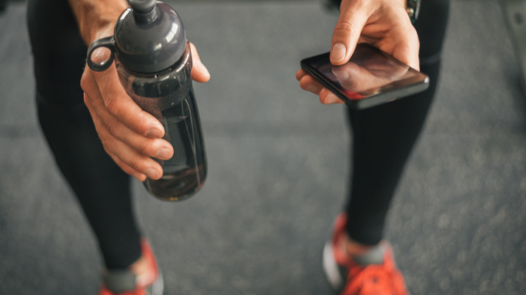 athlete hydrates in gym during workout