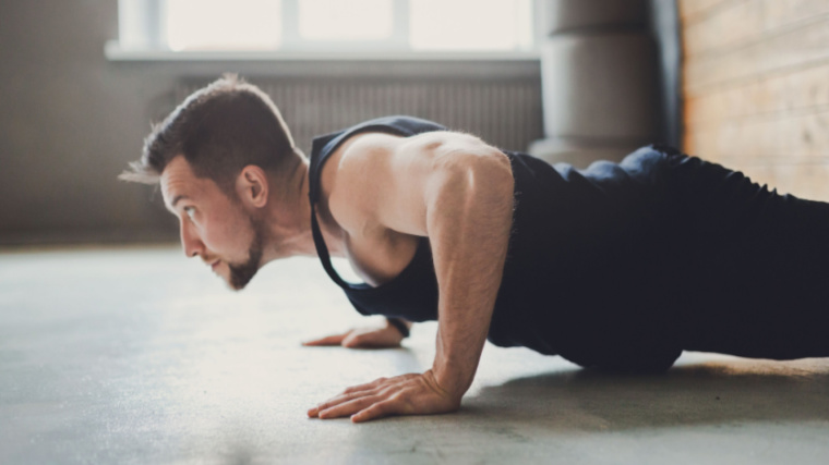 man focuses on chest contraction during push-up