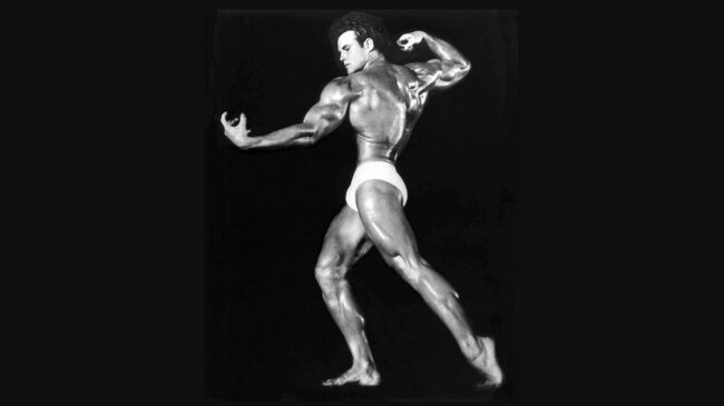 A black-and-white photo of bodybuilder Steve Reeves posing.