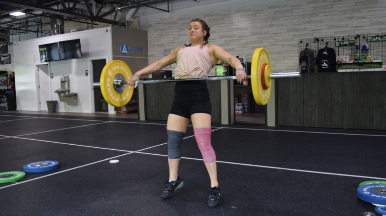 weightlifter extends on snatch exercise