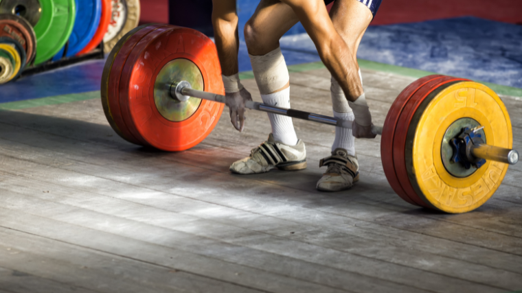 weightlifter prepares for heavy clean & jerk in competition