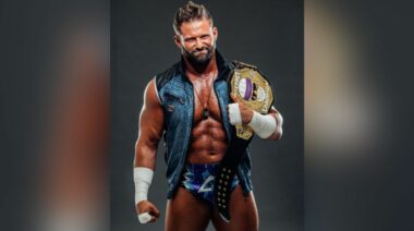 Pro wrestler Matt Cardona poses with a title belt