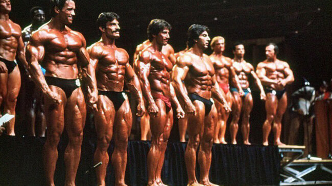 Bodybuilders standing on a stage at the 1980 Mr. Olympia