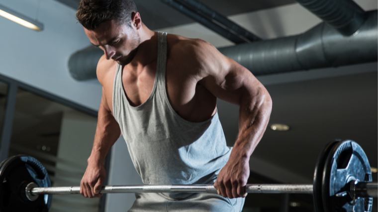 A man works through a set of barbell columns 