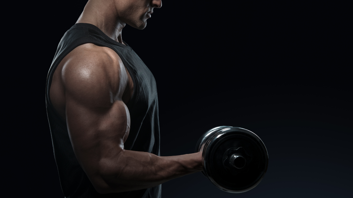 Serious african american athlete lifting dumbbell in tricep curl