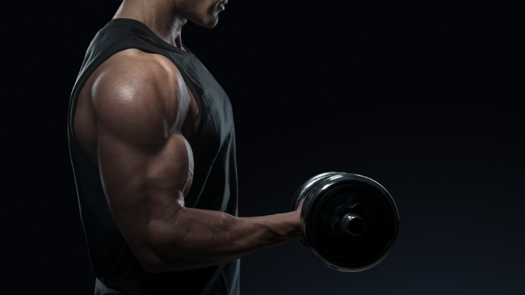 man in tank top performs bicep curl with dumbbell