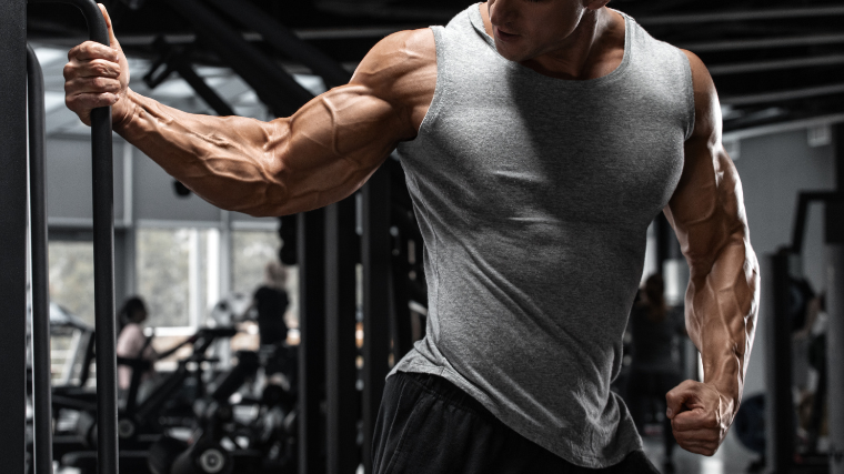 Muscular bodybuilder performs chest stretch