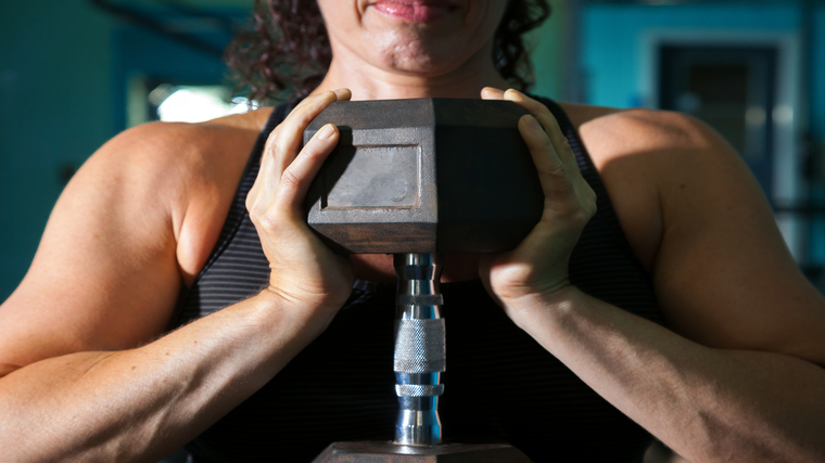 A close-up image shows a person holding a dumbbell in a goblet squat position.
