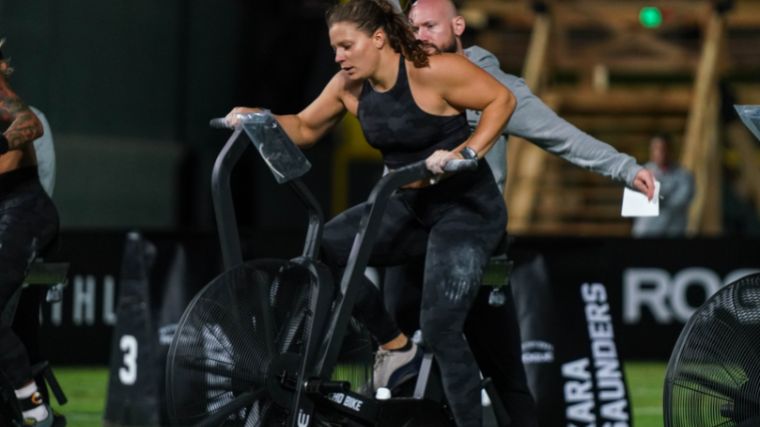 CrossFitter Laura Horvath rides an air bike.