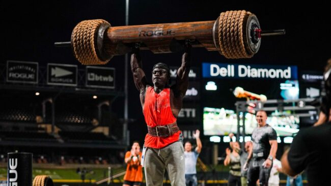 CrossFitter Chandler Smith Presses a 300-pound wooden log over head at the 2022 Rogue Invitational.