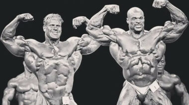 Two shirtless bodybuilders posing next to each other in black and white.