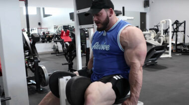 Bodybuilder Hunter Labrada working out his legs on an adductor machine.