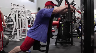 A bodybuilder on a reverse pec deck machine.