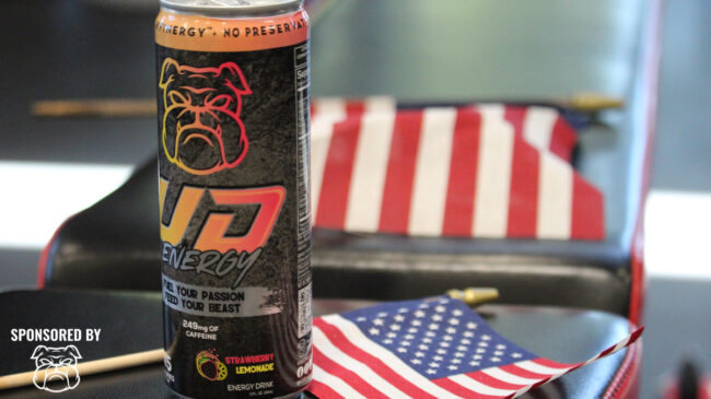 A can of UD Energy sits on a table alongside a small American flag.