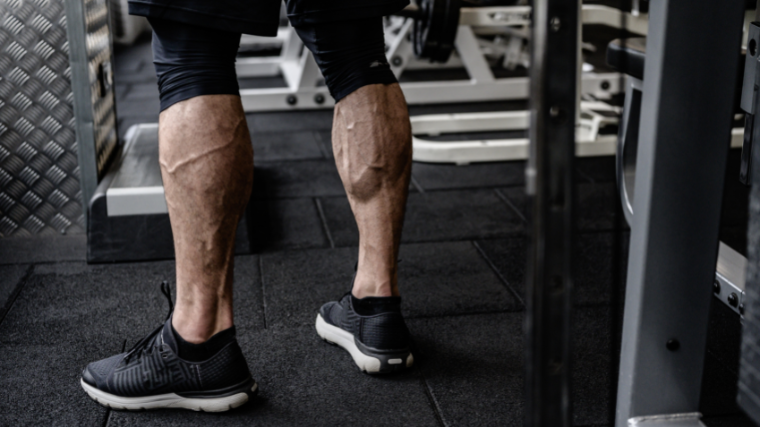 athlete flex calves at gym