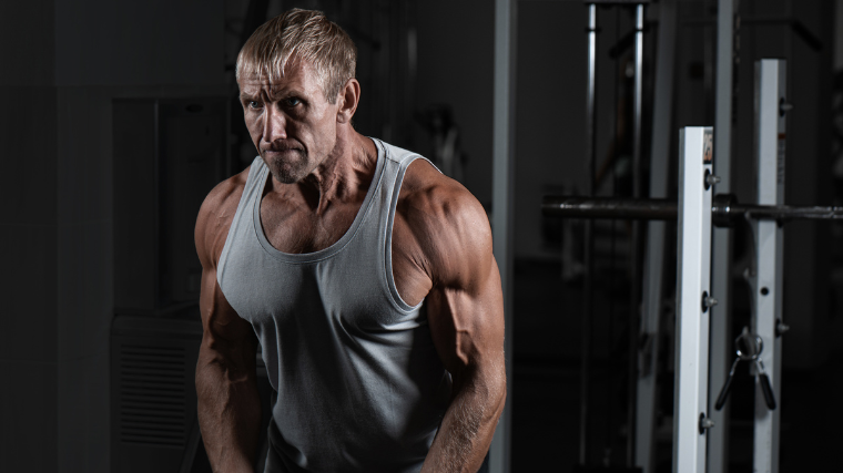 Senior bodybuilder works out in the gym.