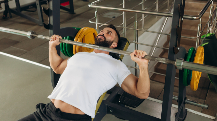 athlete prepares for set of incline bench press