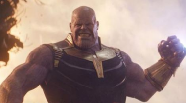 Thanos from the Marvel universe holds up a fist, ready to deliver a blow.