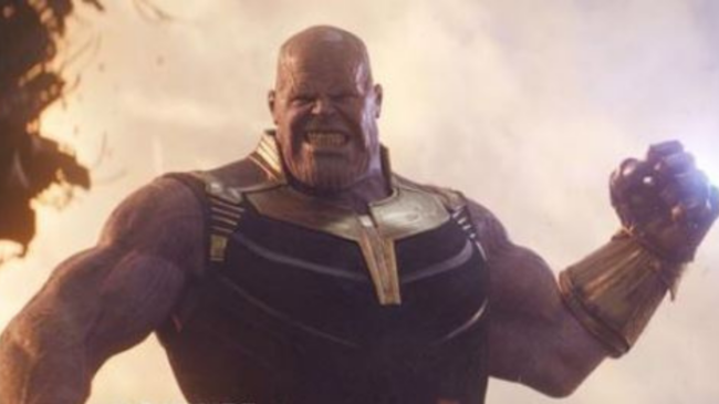 Thanos from the Marvel universe holds up a fist, ready to deliver a blow.