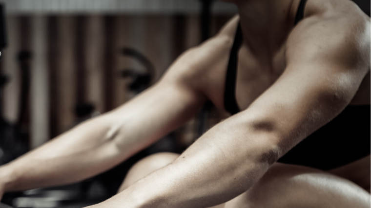 Athlete about to row on machine with both arms