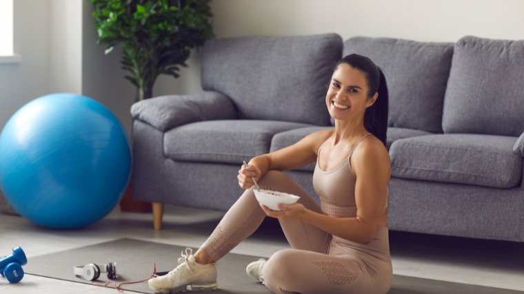 woman eating a bowl of rice before working out at home