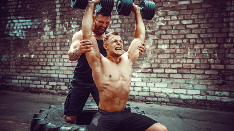 Athlete and spotter help each to break personal record for overhead press