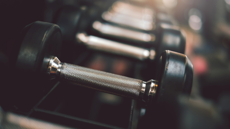 increasing weights of dumbells on top of the rack