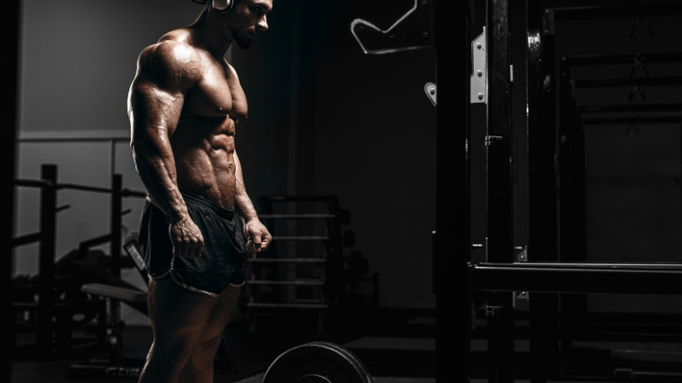 bodybuilder walking onto dumbell on gym floor