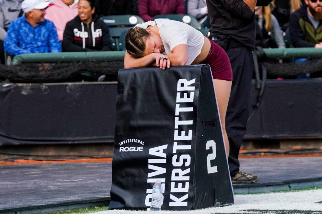 Teen CrossFit sensation Oliva Kerstetter slumps over a foam triangle to rest post-event.