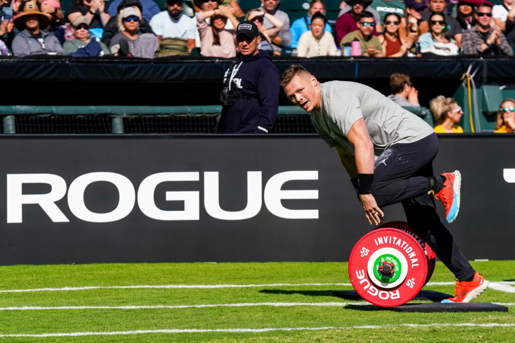 CrossFit athlete leans over the start line of an event at the 2022 Rogue Invitational.