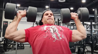 Bodybuilder Jay Cutler performing dumbbell presses.