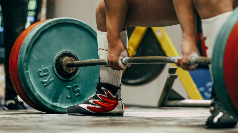 Powerlifter sets up to perform the sumo deadlift in competition