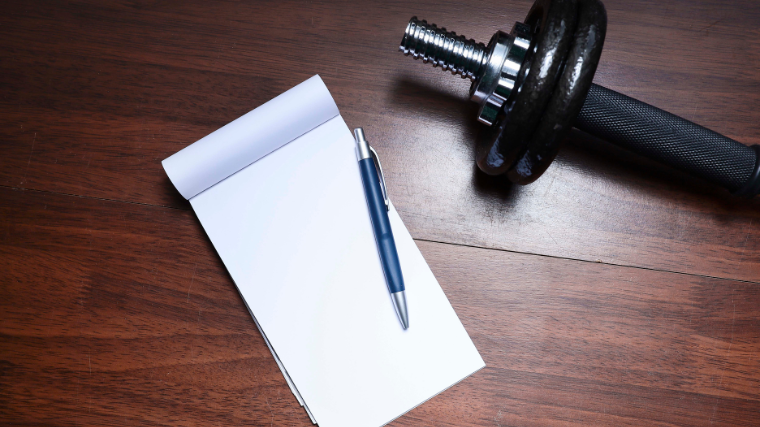 dumbbell and blank workout journal