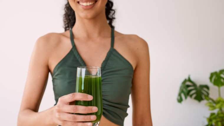 woman drinks greens smoothie 