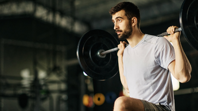 Man focuses intently during step-up exercise