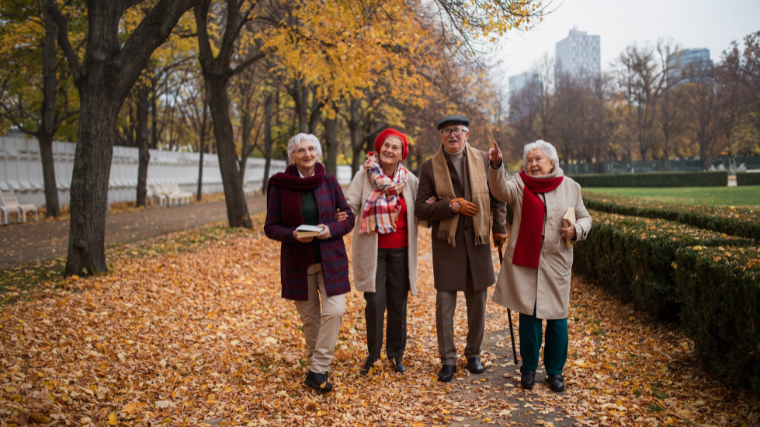 group of senior citizens walking outdoors in city park