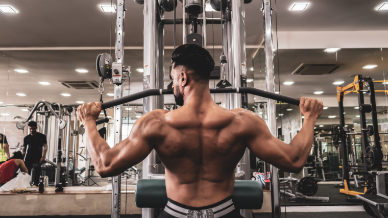 athlete in the gym performing a well executed lat pulldown on machine