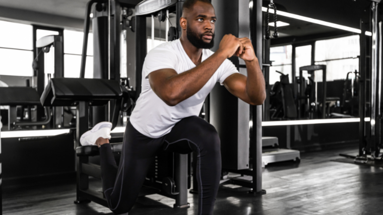 athlete performing bulgarian split squats in the gym