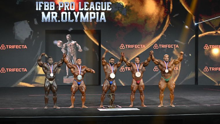 The top 5 Men's Open competitors line up with medals at the 2022 Mr. Olympia