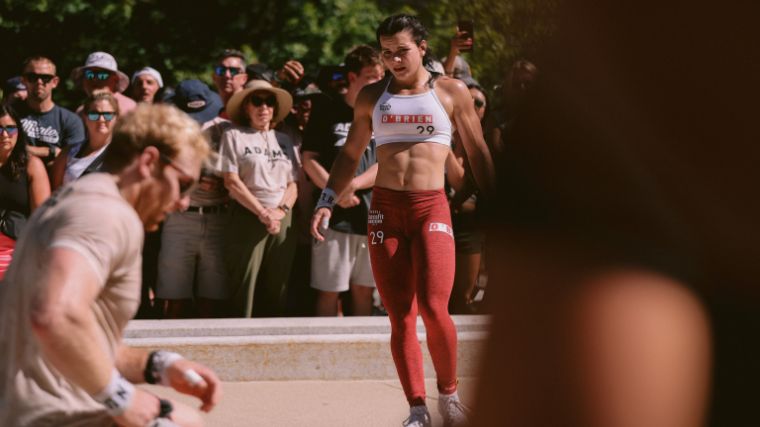 CrossFitter Mallory O'Brien wearing red leggings and a white leader jersey during The Capitol event at the 2022 CrossFit Games.