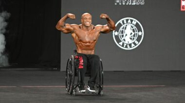 Wheelchair bodybuilder Harold Kelley flexes on stage at the 2022 Mr. Olympia.