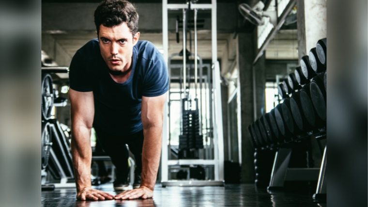 A person concentrating while doing a diamond push-up.