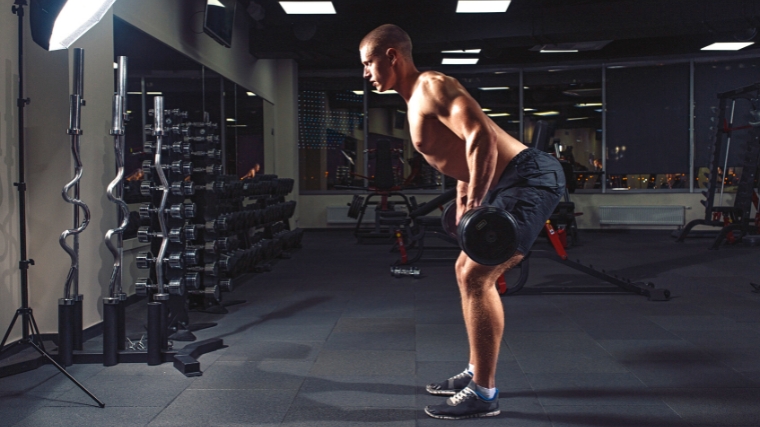 A person weightlifting in the gym.