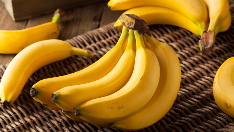 A small bunch of bananas on a placemat.