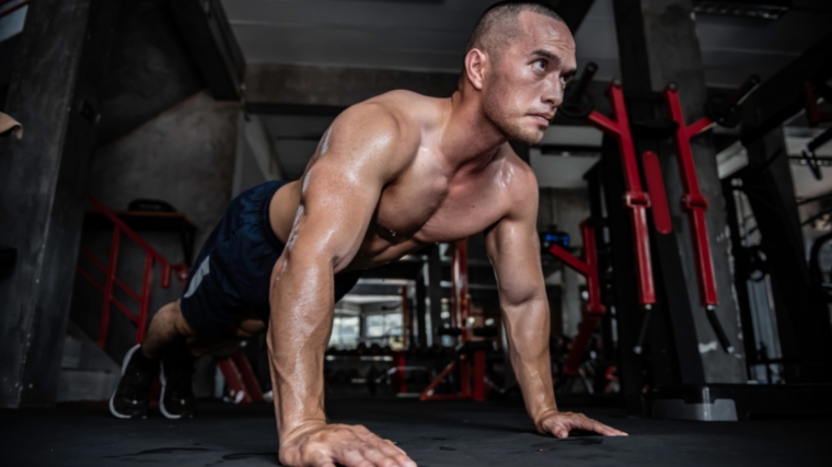 Asian man big muscles training in the gym