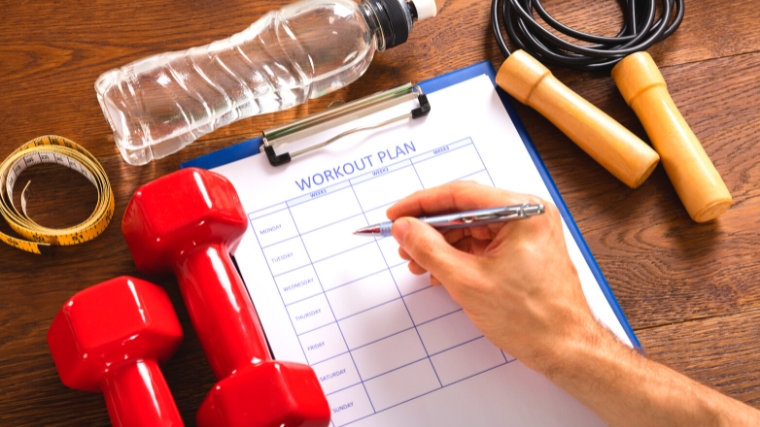 Clipboard with a table of a workout plan.